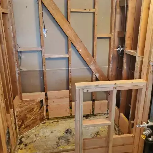 Partially demolished shower in Bullhead City with exposed studs and plumbing, ready for tile installation remodel.