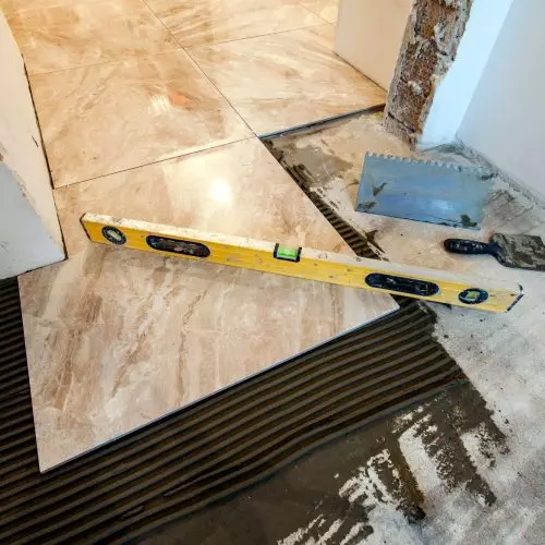 Ceramic tiles and tools for tiler. Floor tiles installation. Home improvement, renovation - ceramic